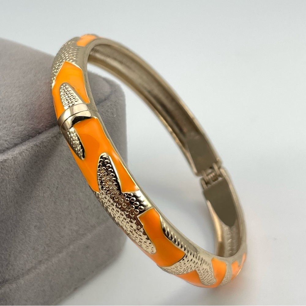 Orange Enamel Gold Tone Hinged Bangle Bracelet with Textured Starfish Design